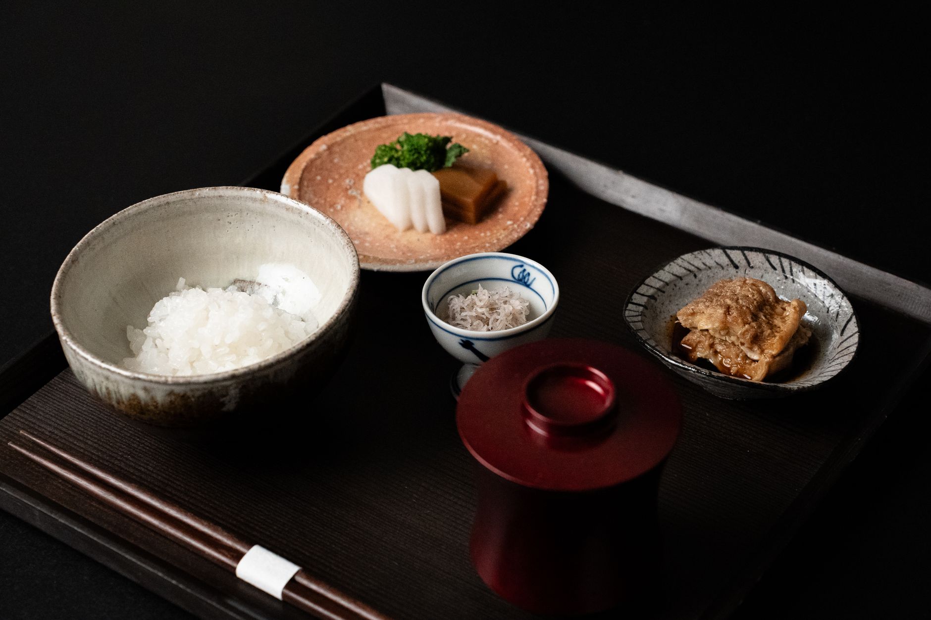 Traditional Japanese tea room with tatami mats and stone lantern garden
